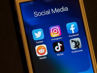 Smartphone with social media icons including Tik Tok